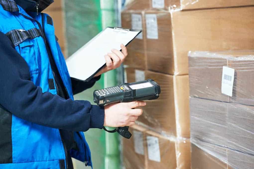 worker using warehouse technology to scan product