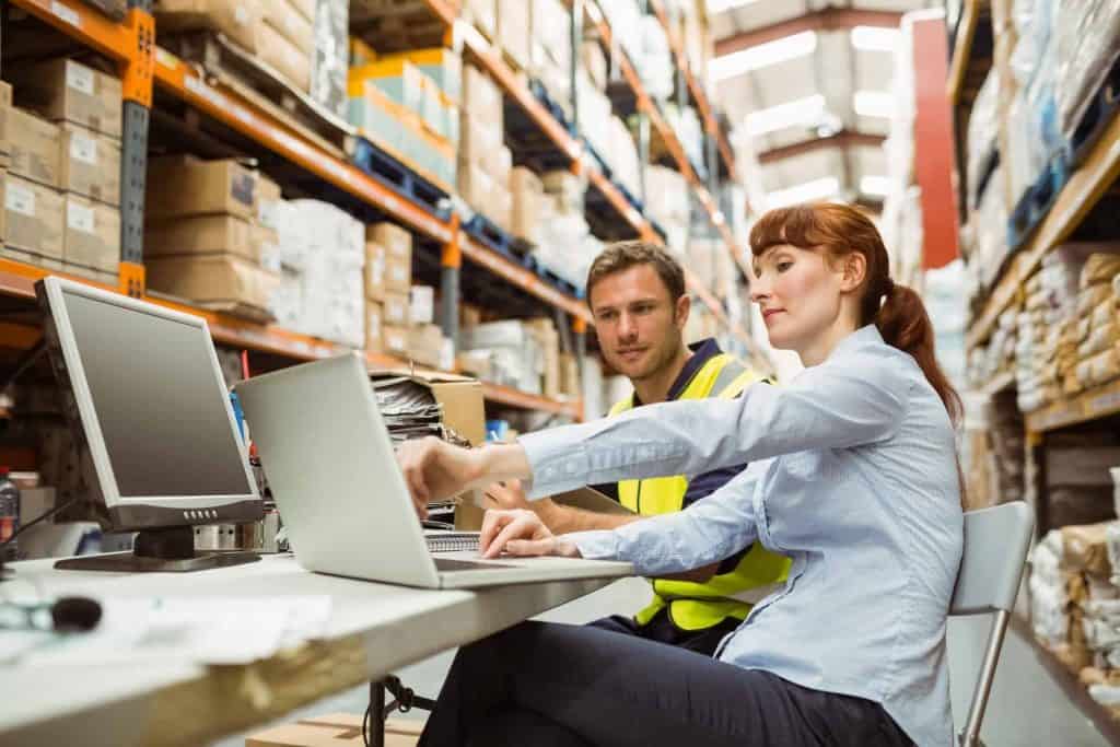 Warehouse worker and manager taking warehouse management course; what is a wms